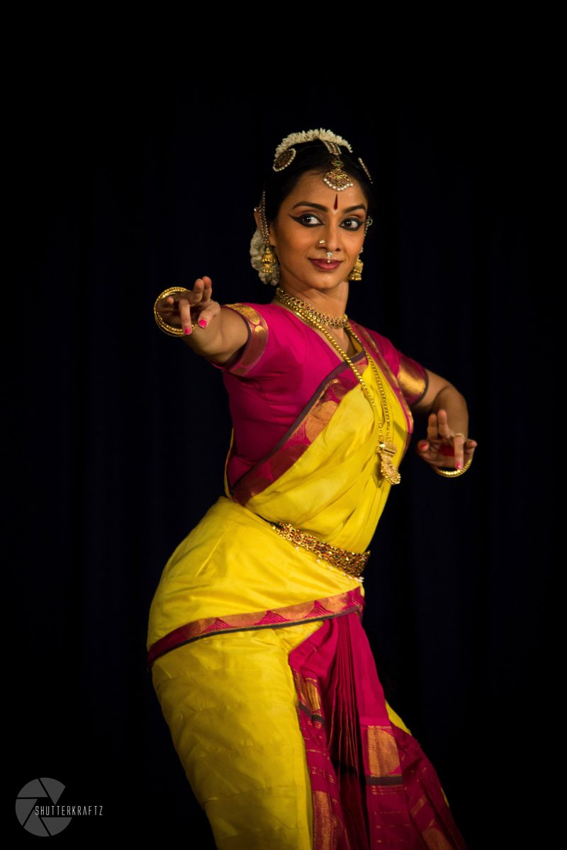 Standing in a yellow and pink costume
