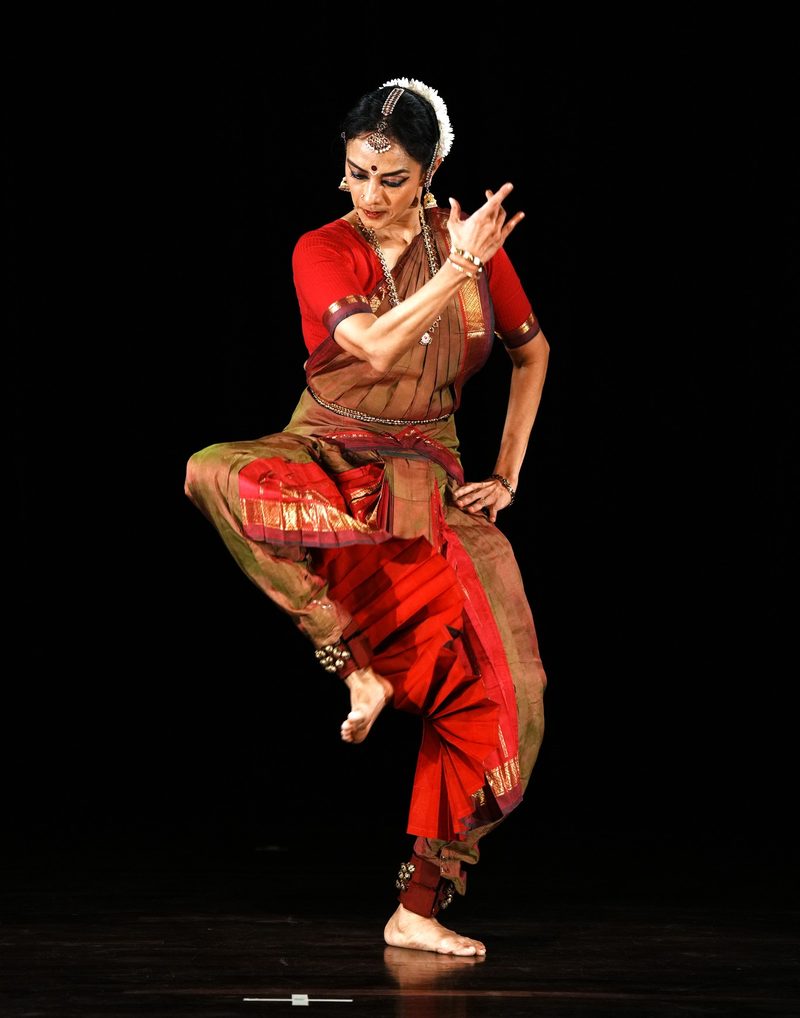 Balanced on one leg in red